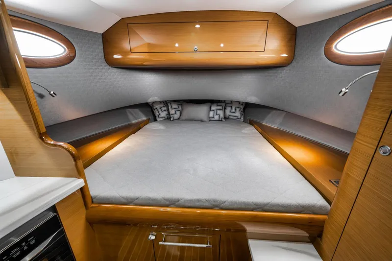 Slide: The Image of Luxurious cabin interior of 2022 Winter Custom Yachts 38 Walk Around, featuring elegant wood finishes. - 25
