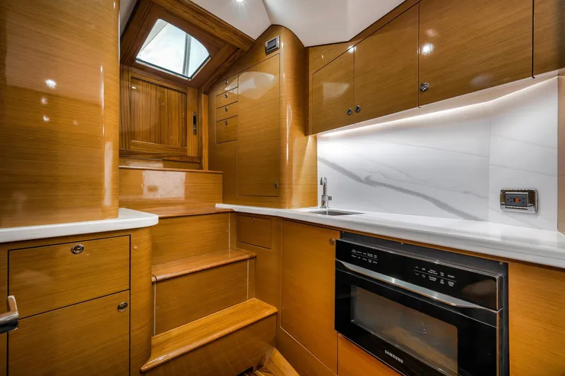 Slide: The Image of Luxurious interior of 2022 Winter Custom Yachts 38 Walk Around, featuring modern kitchen amenities. - 26