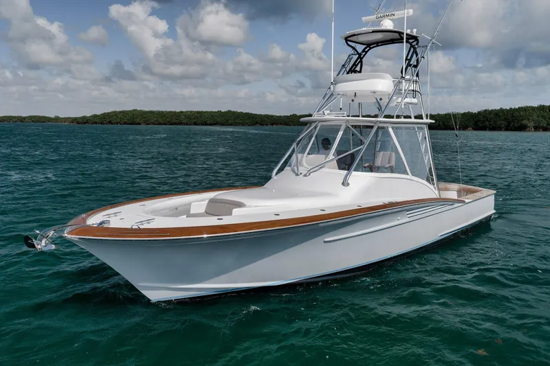 Slide: The Image of 2022 Winter Custom Yachts 38 Walk Around on open water under a cloudy sky. - 3