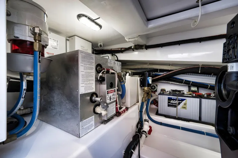 Slide: The Image of Engine room of 2022 Winter Custom Yachts 38 Walk Around, showcasing mechanical components and wiring. - 30