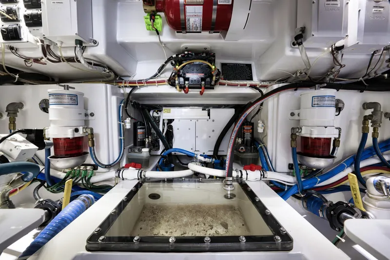 Slide: The Image of Engine room of 2022 Winter Custom Yachts 38 Walk Around, showcasing complex machinery and wiring. - 31