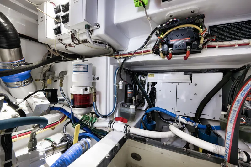 Slide: The Image of Engine room of 2022 Winter Custom Yachts 38 Walk Around, showcasing complex wiring and components. - 32