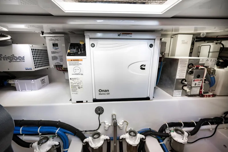 Slide: The Image of Engine room of 2022 Winter Custom Yachts 38 Walk Around, featuring Onan Marine QD generator. - 33