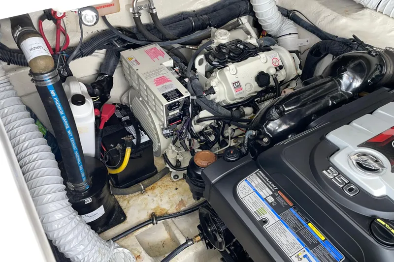 Slide: The Image of Engine compartment of a 2019 Rinker 370 EX boat, featuring a Mercury 350 engine. - 31