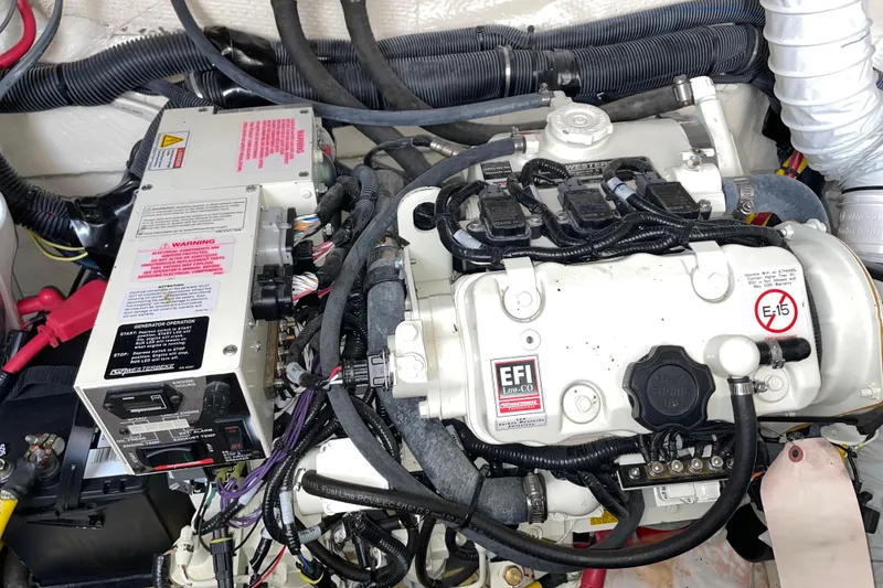 Slide: The Image of Engine compartment of a 2019 Rinker 370 EX boat, featuring EFI system and wiring. - 32