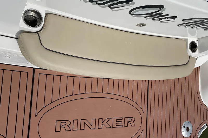 Slide: The Image of 2019 Rinker 370 EX boat deck with cushioned seating and branded flooring. - 36
