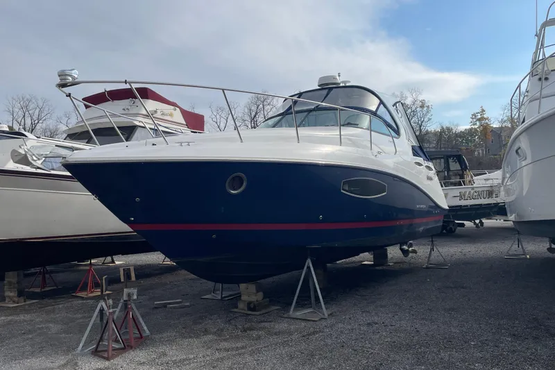 Slide: The Image of 2019 Rinker 370 EX boat on stands in a marina storage area. - 7