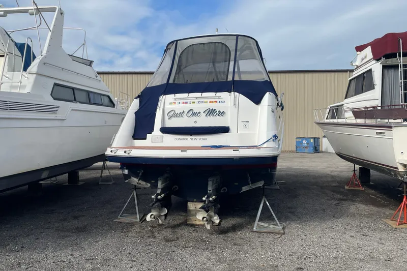Slide: The Image of 2019 Rinker 370 EX boat on stands, rear view, in a boatyard. - 9