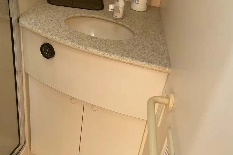 Slide: The Image of 1999 Silverton 360 Express bathroom sink with granite countertop and storage cabinets. - 20