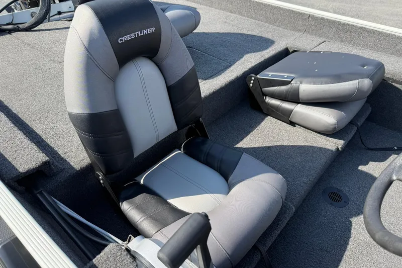 Slide: The Image of 2023 Crestliner 1700 Storm boat interior with cushioned seating and carpeted flooring. - 10