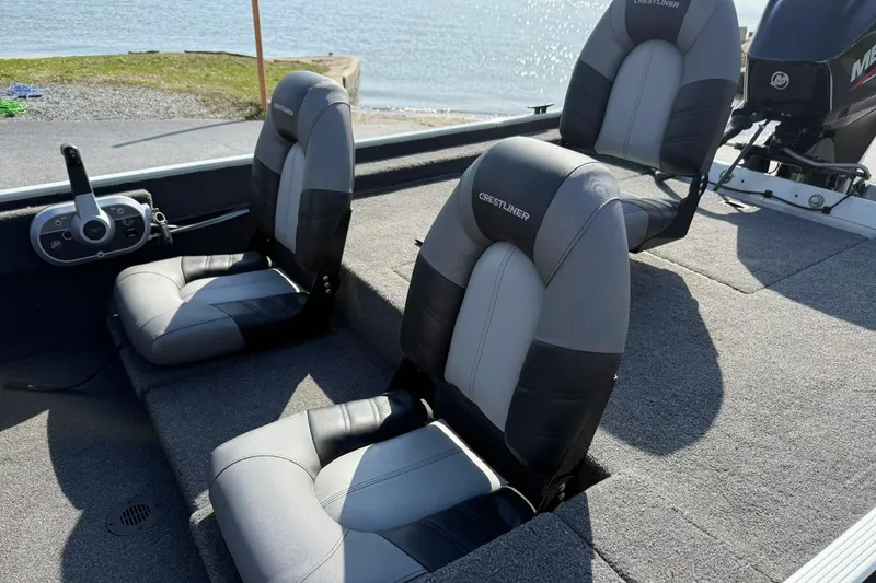 Slide: The Image of 2023 Crestliner 1700 Storm boat interior with two cushioned seats near the water. - 11