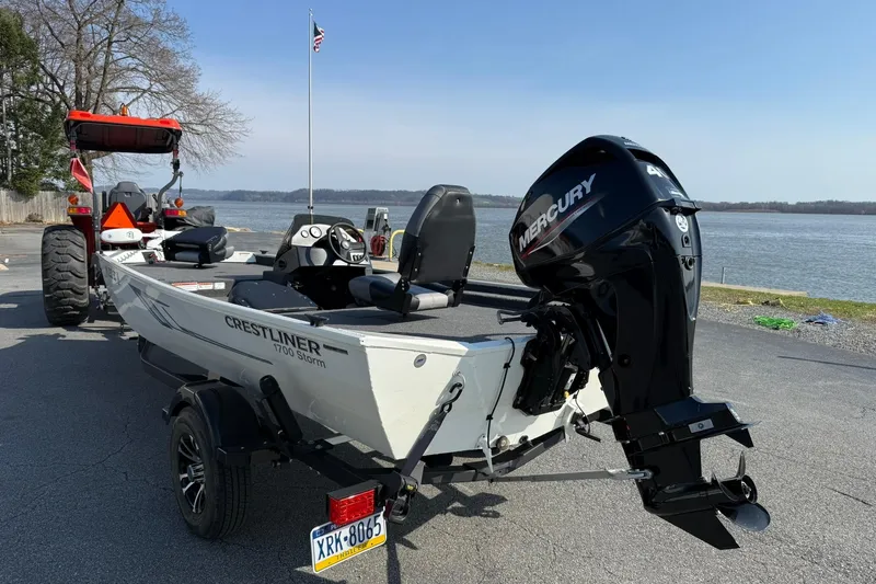 Slide: The Image of 2023 Crestliner 1700 Storm boat with Mercury engine, parked near a lake. - 3
