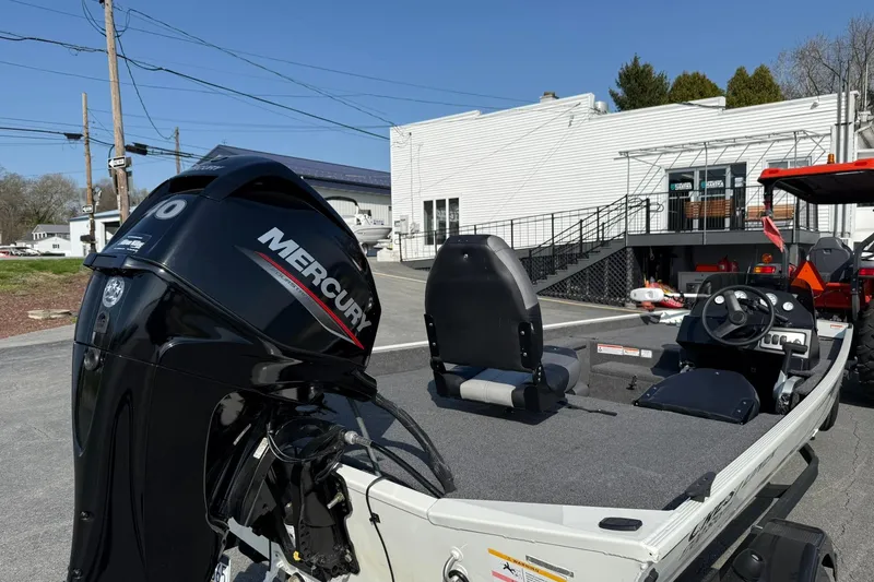 Slide: The Image of 2023 Crestliner 1700 Storm boat with Mercury outboard motor, parked outdoors. - 4