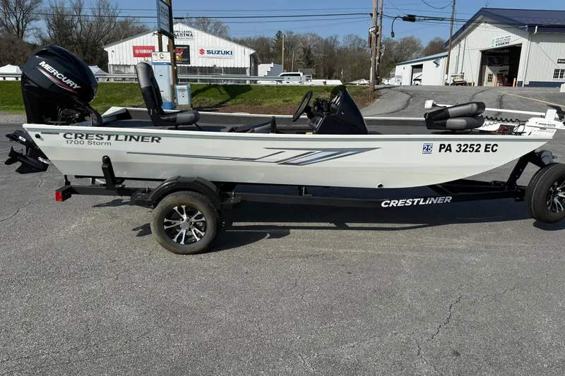 Slide: The Image of 2023 Crestliner 1700 Storm boat on trailer, parked outdoors near dealership. - 5