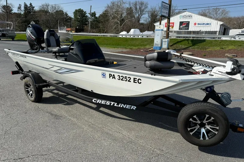 Slide: The Image of 2023 Crestliner 1700 Storm boat on trailer, parked outdoors, featuring sleek design and modern equipment. - 6