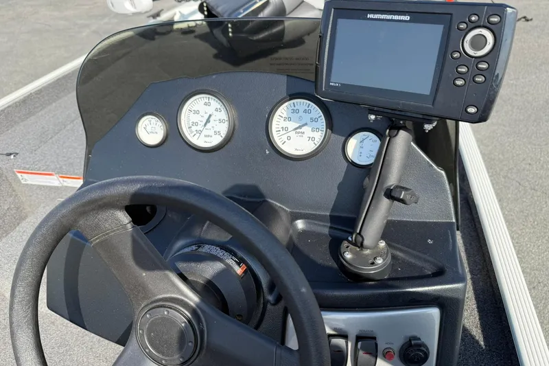 Slide: The Image of 2023 Crestliner 1700 Storm dashboard with steering wheel, gauges, and Humminbird fish finder. - 9