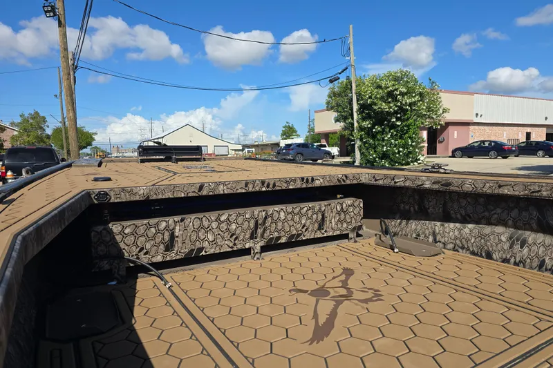 Slide: The Image of Pro-Drive 2272 boat, 2026 model, with camouflage design, parked in an urban area. - 11