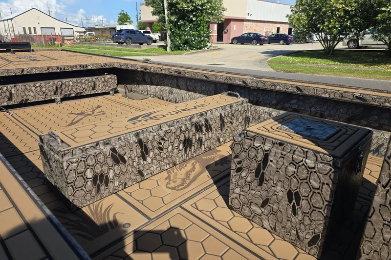 Slide: The Image of Interior of 2026 Pro-Drive 2272 boat with hexagonal camo pattern and storage compartments. - 12