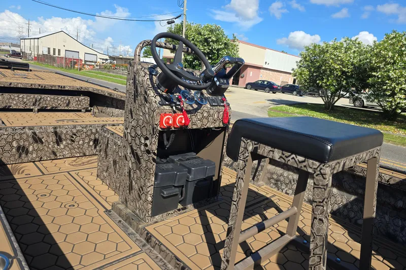 Slide: The Image of Pro-Drive 2272 boat interior with camouflage design, steering console, and seating, 2026 model. - 13