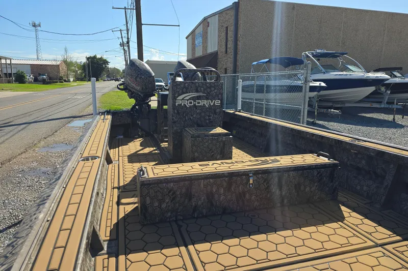 Slide: The Image of 2026 Pro-Drive 2272 boat with camouflage design, parked outdoors near other boats. - 17