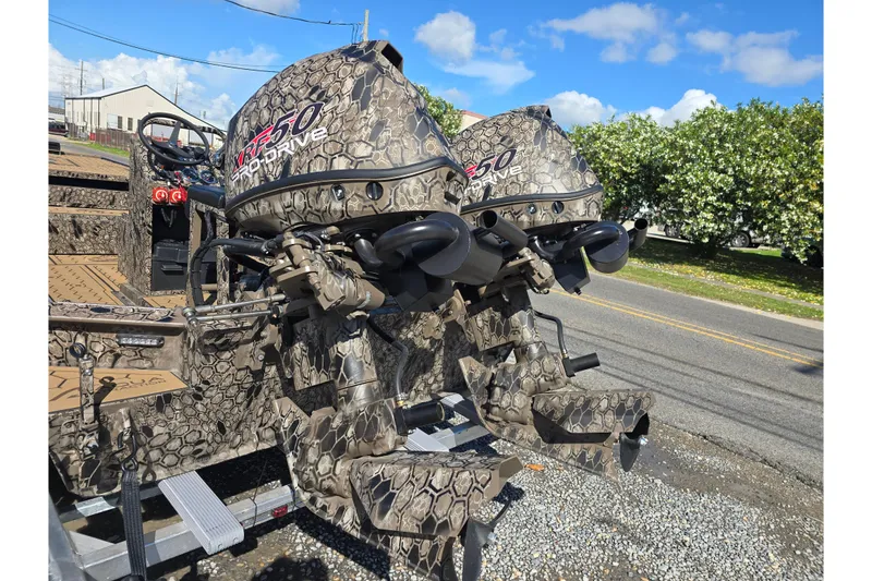 Slide: The Image of Camouflage-patterned Pro-Drive 2272 boat motors, 2026 model, parked outdoors under a clear sky. - 20