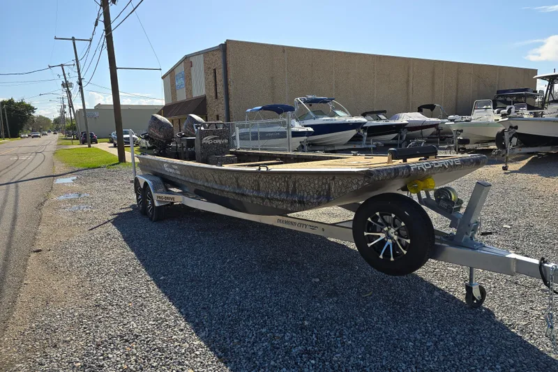 Slide: The Image of 2026 Pro-Drive 2272 boat on trailer, parked on gravel near other boats. - 4