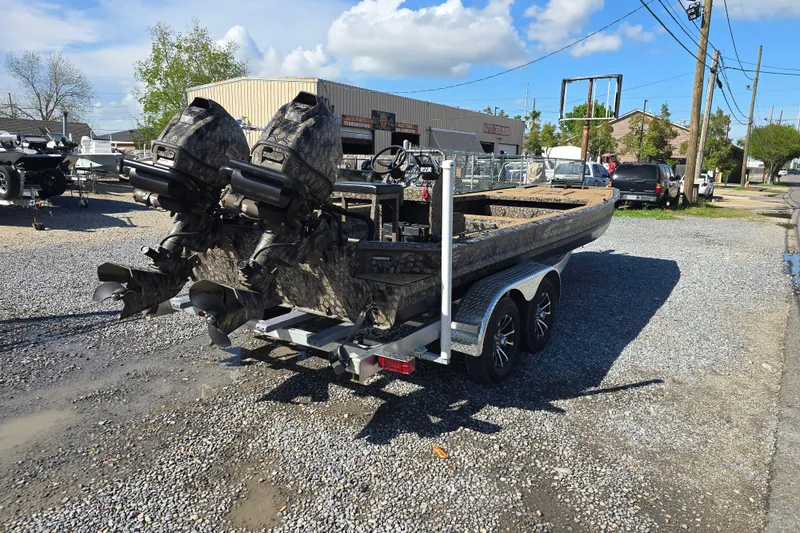 Slide: The Image of Pro-Drive 2272 boat on trailer, dual motors, parked on gravel lot, sunny day, 2026 model. - 7