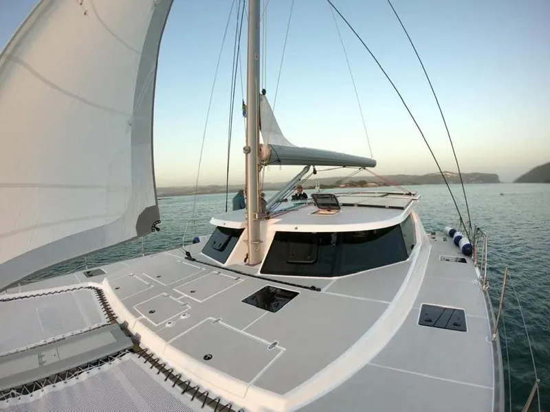 Slide: The Image of Sailing catamaran Vision 444, 2025 model, cruising on calm waters at sunset. - 19