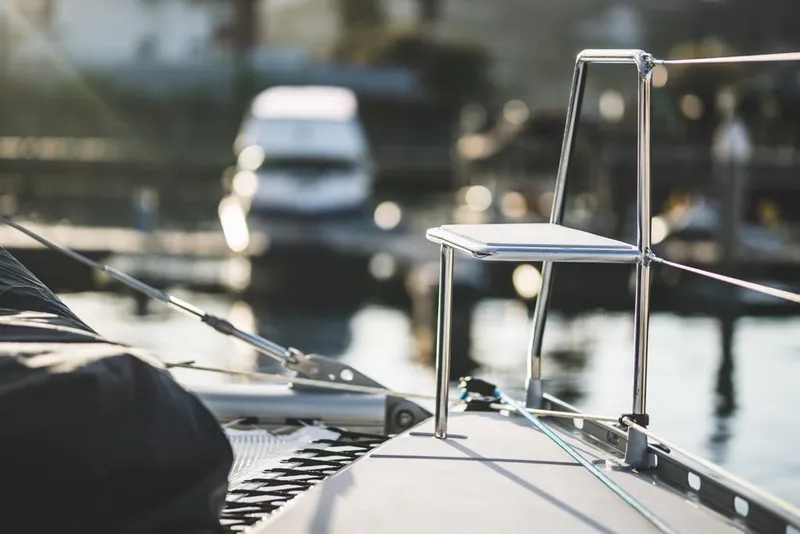 Slide: The Image of Sleek Vision 444 yacht deck with modern chair, 2025 model, docked at marina. - 24