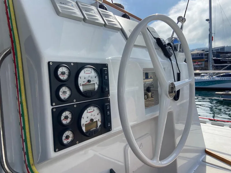 Slide: The Image of Vision 444 yacht steering wheel and control panel, docked at marina, 2025 model. - 32