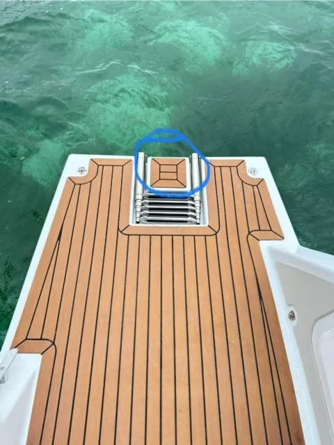 Slide: The Image of Vision 444 2025 boat deck with wooden finish and ladder, overlooking clear water. - 35