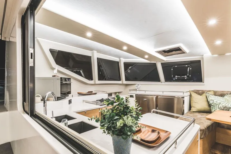 Slide: The Image of Luxurious Vision 444 yacht interior, featuring modern kitchen and seating area, 2025 model. - 42