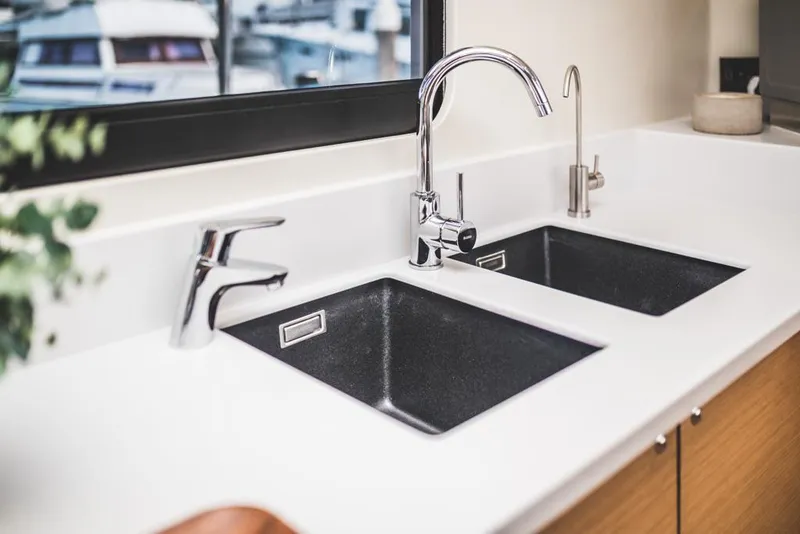 Slide: The Image of Modern kitchen sink with dual basins and sleek chrome faucets, Vision 444 model, 2025. - 47