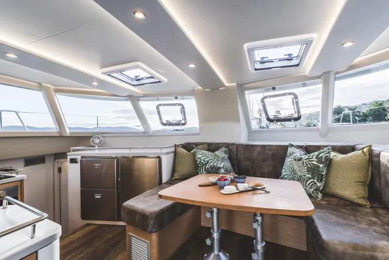 Slide: The Image of Luxurious Vision 444 yacht interior with modern seating and dining area, 2025 model. - 49