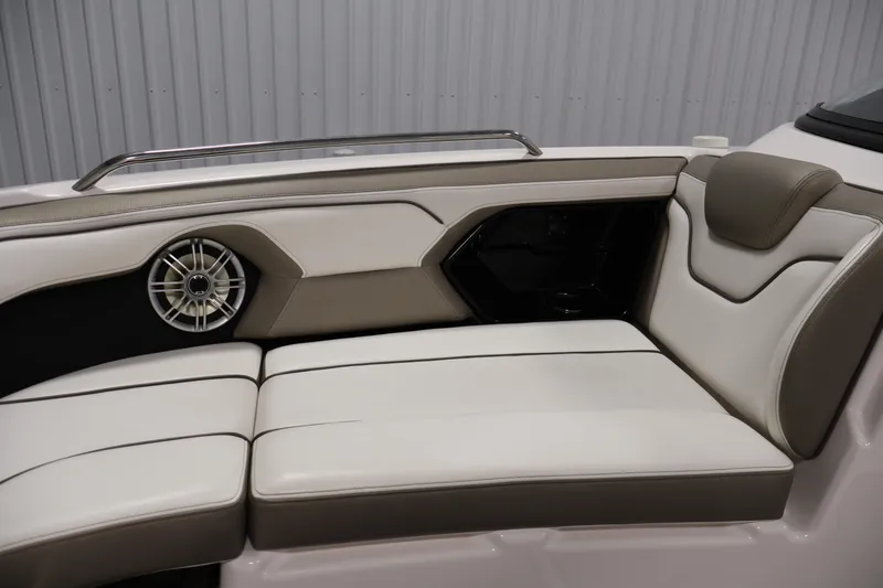Slide: The Image of 2017 Yamaha Boats 212 Limited S interior seating with speaker, featuring beige and white upholstery. - 15