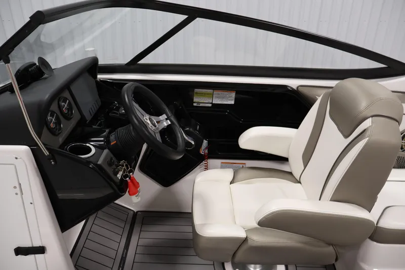 Slide: The Image of 2017 Yamaha Boats 212 Limited S cockpit with steering wheel and comfortable seating. - 19