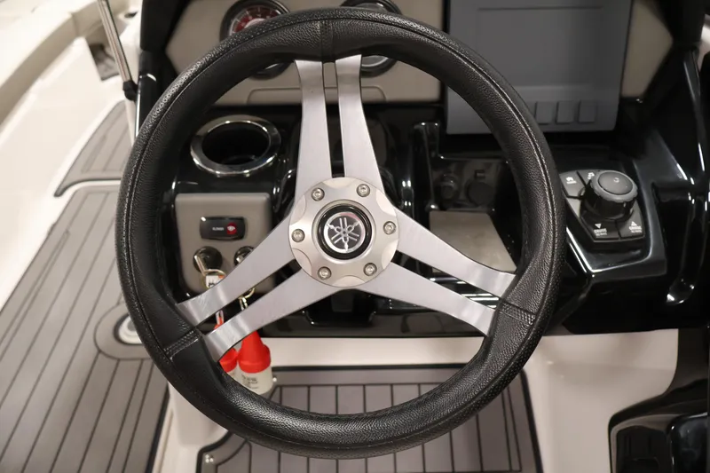 Slide: The Image of Steering wheel of 2017 Yamaha Boats 212 Limited S, featuring sleek design and controls. - 21