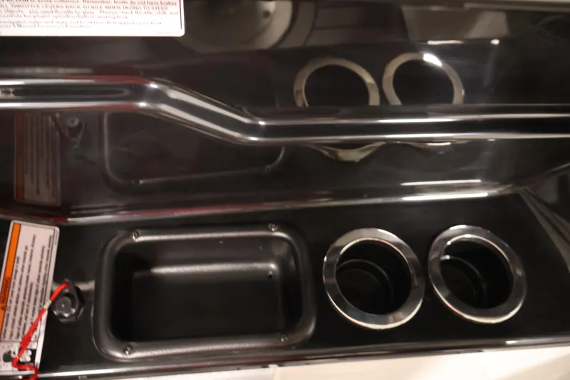 Slide: The Image of 2017 Yamaha Boats 212 Limited S interior with cup holders and storage compartment. - 27
