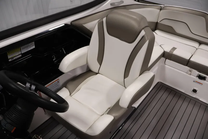 Slide: The Image of 2017 Yamaha Boats 212 Limited S interior with plush seating and steering wheel. - 28
