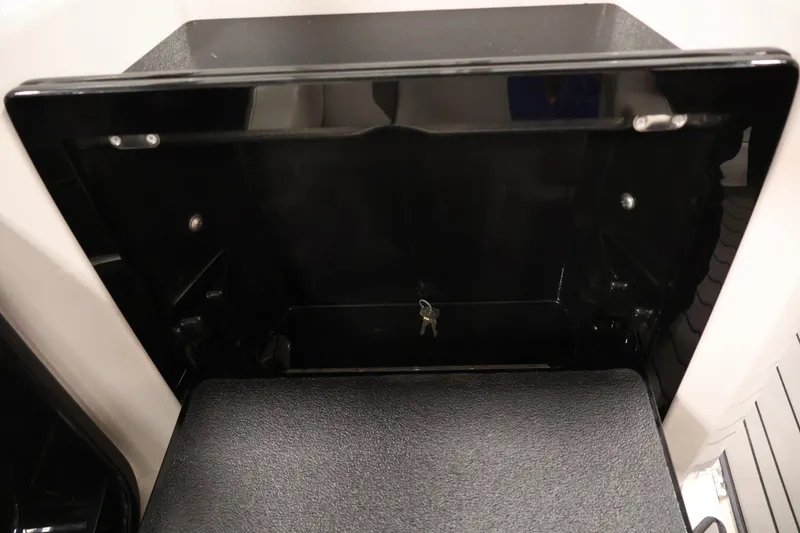 Slide: The Image of Storage compartment with keys in a 2017 Yamaha Boats 212 Limited S. - 32