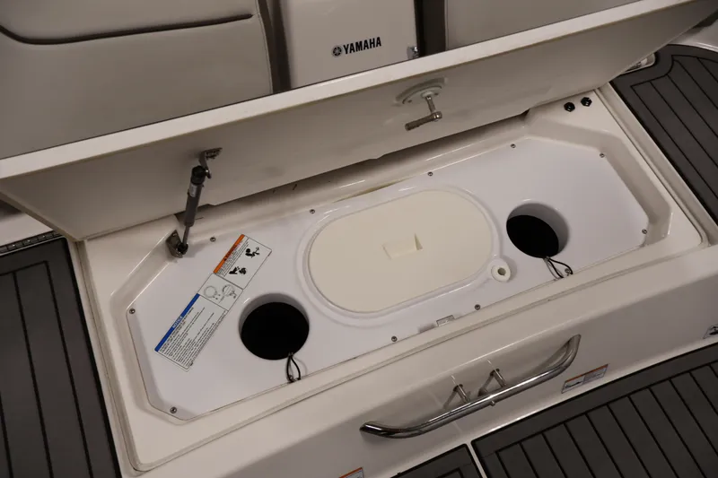Slide: The Image of 2017 Yamaha Boats 212 Limited S storage compartment with open lid, showcasing interior features. - 41
