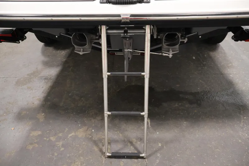 Slide: The Image of 2017 Yamaha Boats 212 Limited S with extended swim ladder on a concrete floor. - 44