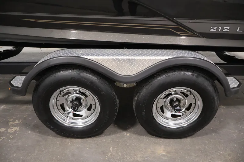 Slide: The Image of Trailer wheels of a 2017 Yamaha Boats 212 Limited S, featuring dual axles. - 48