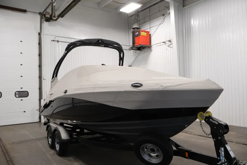 Slide: The Image of 2017 Yamaha Boats 212 Limited S covered in a garage, on a trailer. - 49