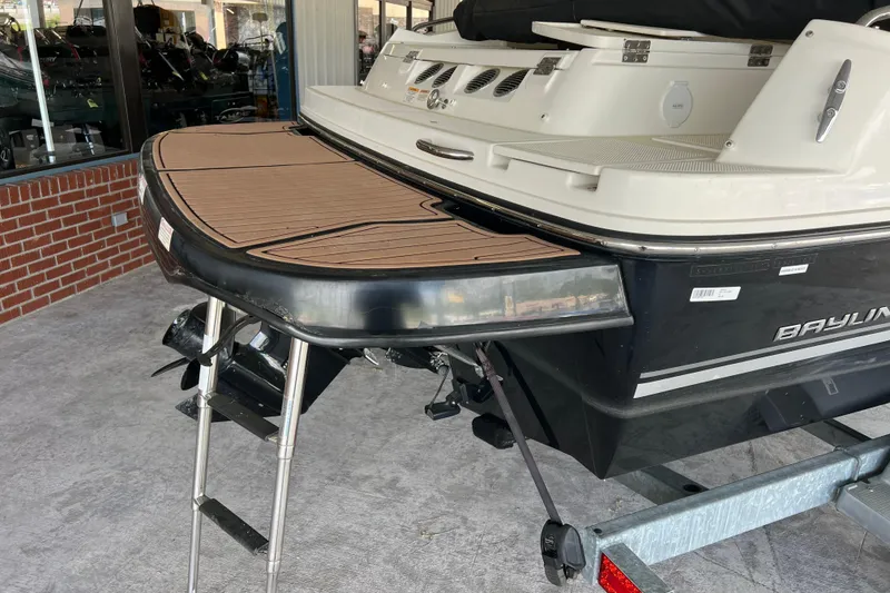 Slide: The Image of 2017 Bayliner 195 Deck Boat rear view with swim platform and ladder. - 10