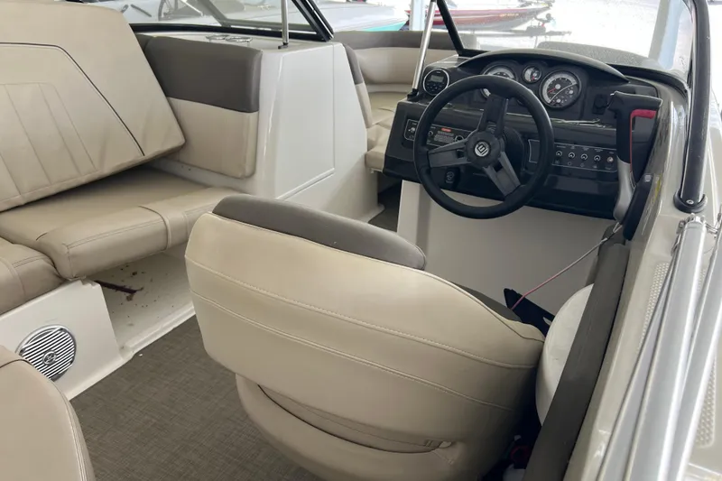 Slide: The Image of Interior of a 2017 Bayliner 195 Deck Boat featuring steering wheel and seating. - 13