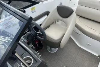 Slide: The Image of 2017 Bayliner 195 Deck Boat interior with steering wheel and seating area. - 7