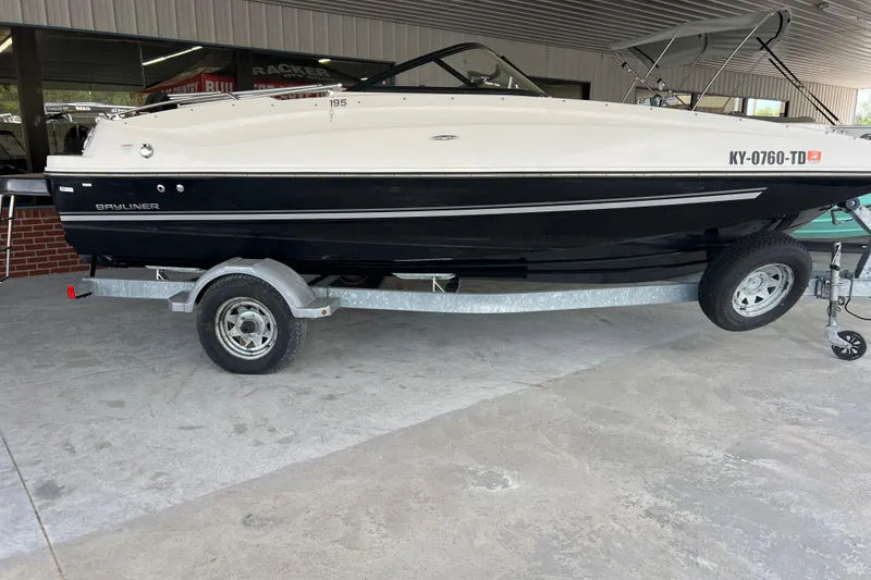 Slide: The Image of 2017 Bayliner 195 Deck Boat on trailer, parked indoors, side view. - 8