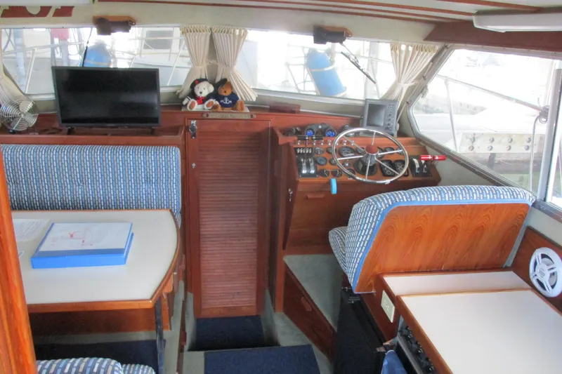 Slide: The Image of Interior of a 1988 Commander 26 boat with helm, seating, and navigation equipment. - 11