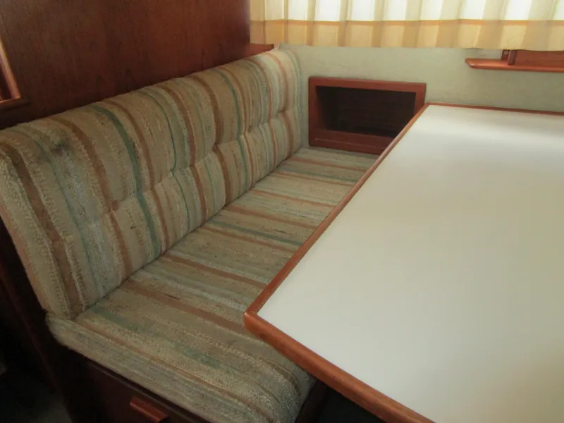 Slide: The Image of Interior of a 1988 Commander 26 with upholstered seating. - 18